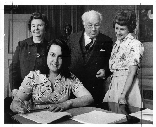 NSGEU members signing around a table